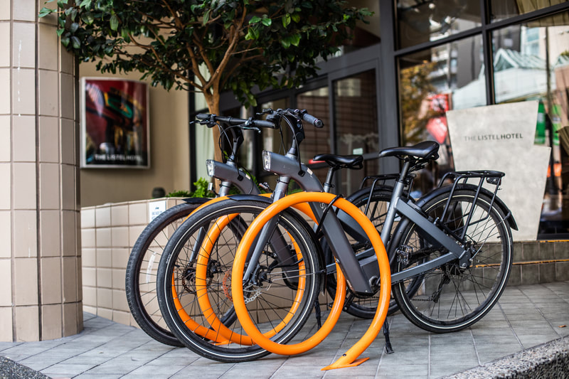 black bicycles at orange bike rack